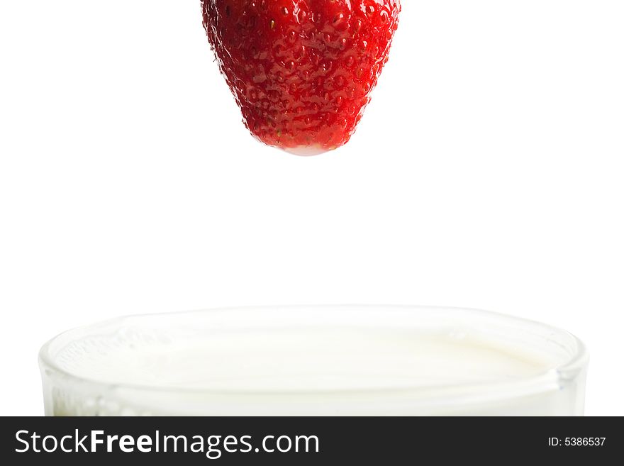 Part of berry and glass with milk