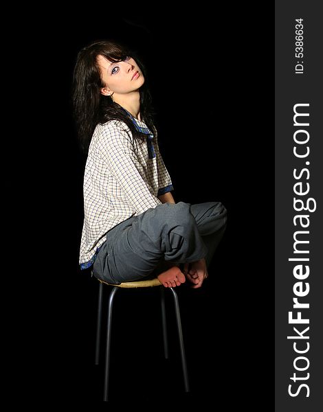 Young woman in village shirt sits on the chair. Young woman in village shirt sits on the chair