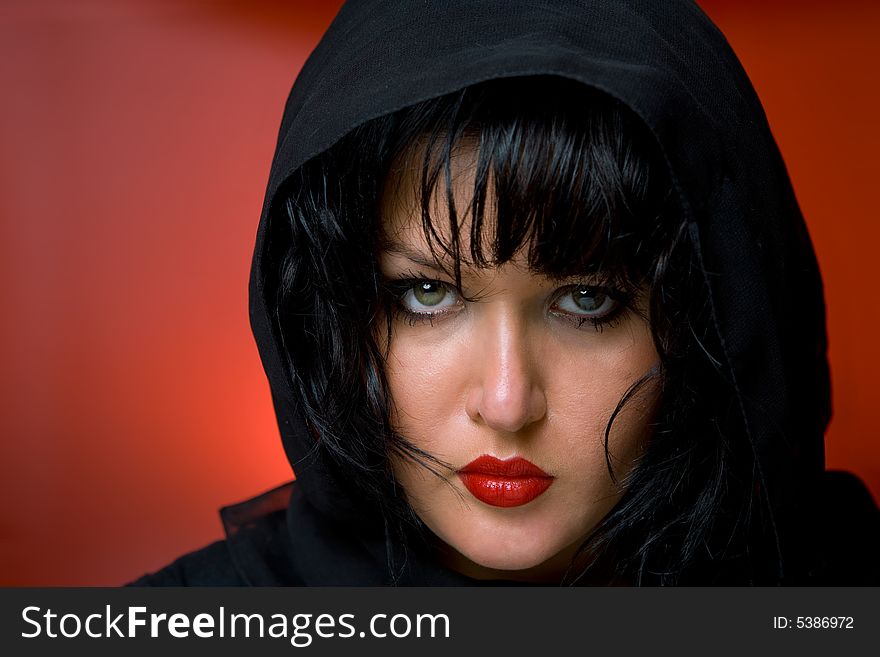 Portrait of young nice woman in black veil on red back. Portrait of young nice woman in black veil on red back