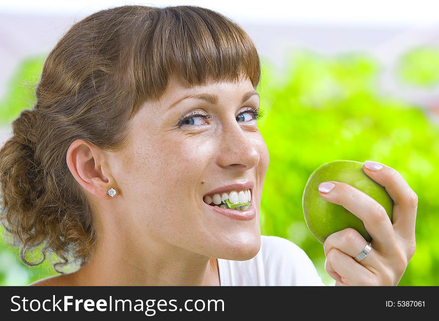 High key portrait of young woman with apple. High key portrait of young woman with apple