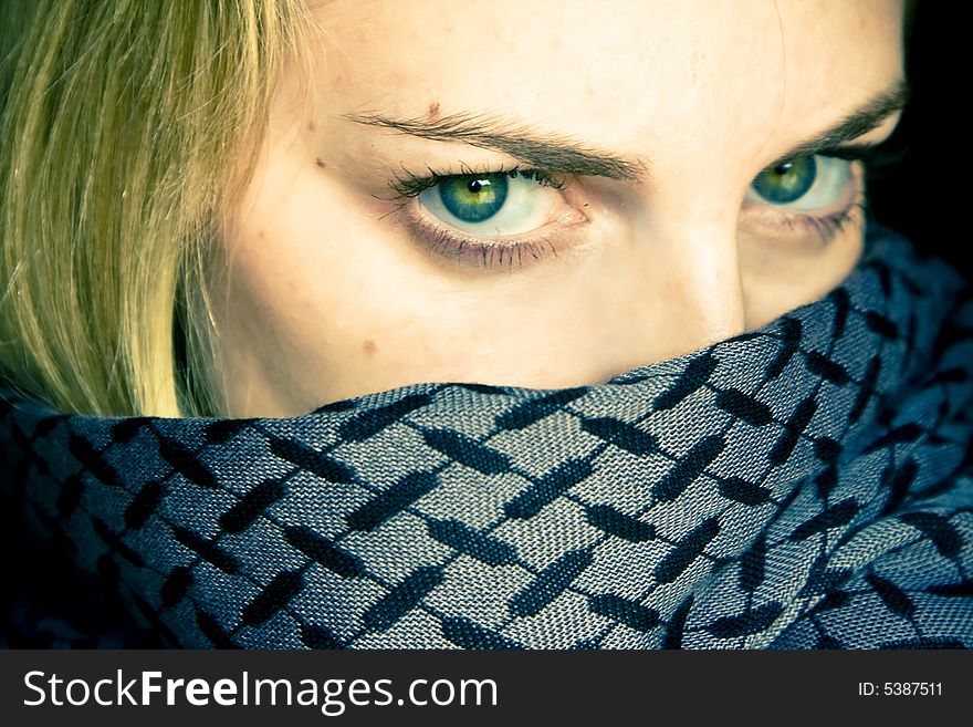 Green eyed beauty with covered face by veil.