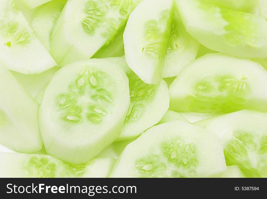 Cucumber slices into pieces as background.