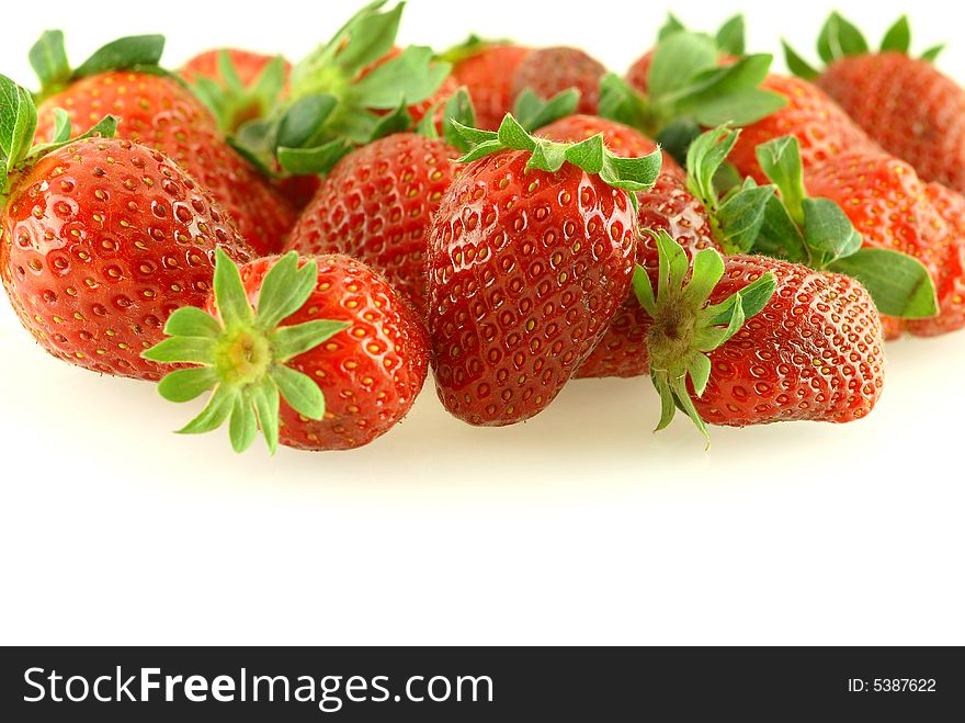 Lots of fresh ripe strawberries over white background. Shallow DOF