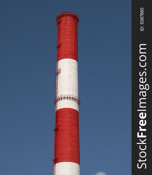 Red and white striped chimney of a power station. Red and white striped chimney of a power station