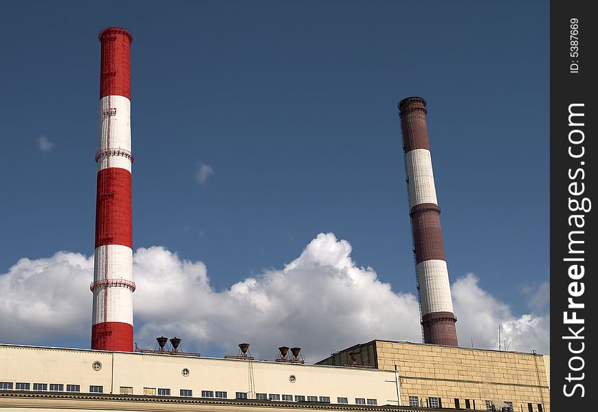 Red and white striped chimneys of a power station. Red and white striped chimneys of a power station