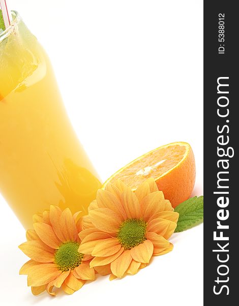 Glass of orange juice and flowers against white background. Glass of orange juice and flowers against white background