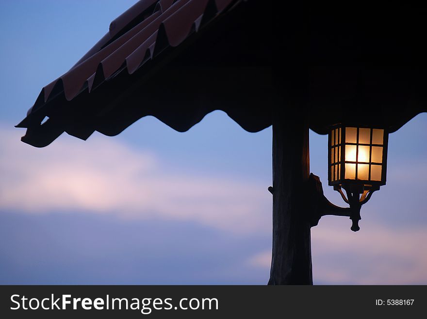 Streetlamp light under ceiling with moon at the top of the sky. Landscape nocturne. Streetlamp light under ceiling with moon at the top of the sky. Landscape nocturne