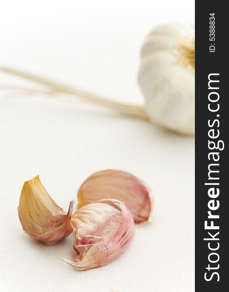Garlic and cloves on the white kitchen table