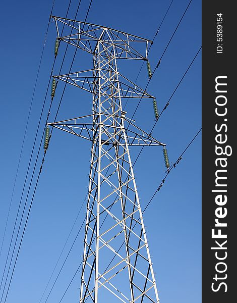 Electric cables and tower in the blue sky. Electric cables and tower in the blue sky.