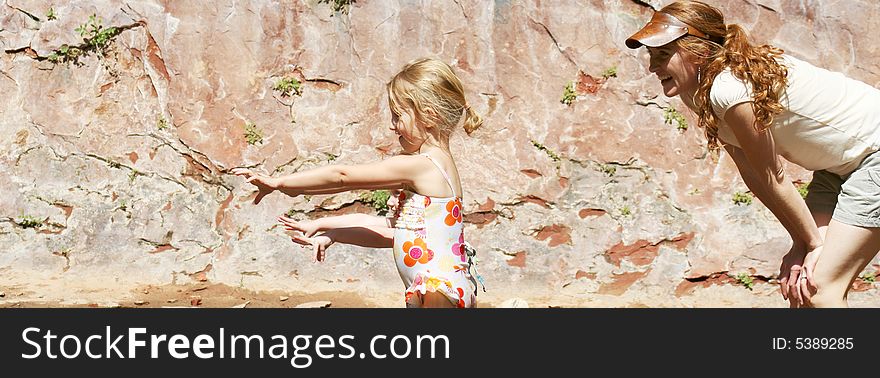 A Beautiful Young Mother and Her Two Adorable Daughters Enjoy the Outdoors and Anticipate Something Fun Coming Their Way. A Beautiful Young Mother and Her Two Adorable Daughters Enjoy the Outdoors and Anticipate Something Fun Coming Their Way