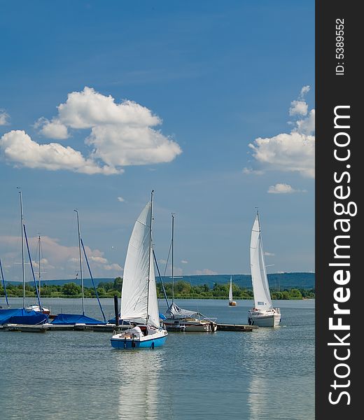 Sailboat moving to moorage on the lake
