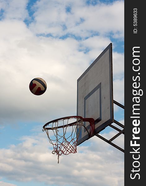 Basketball hoop against the cloudy sky