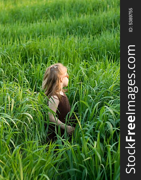 The child in a high marsh grass. The child in a high marsh grass