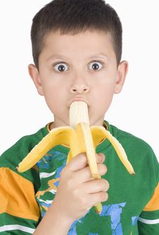 Boy Eating Banana Stock Images
