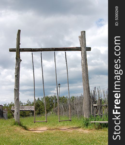 Ancient wooden swing in an ethnographic museum. Ancient wooden swing in an ethnographic museum
