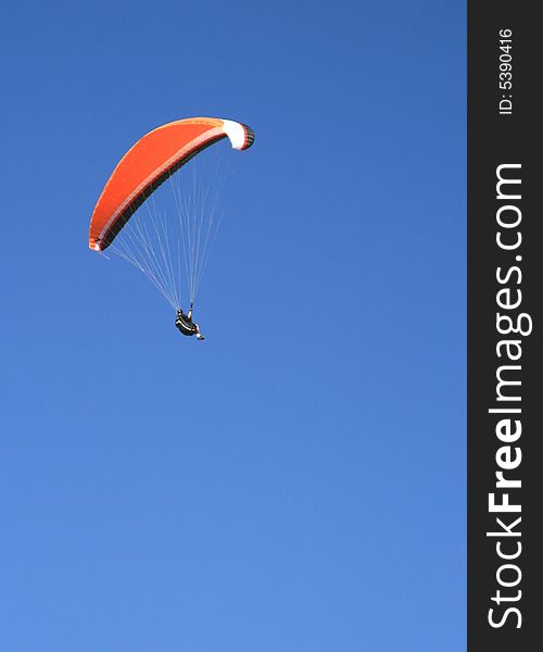 Paraglider flying against the blue sky. Paraglider flying against the blue sky