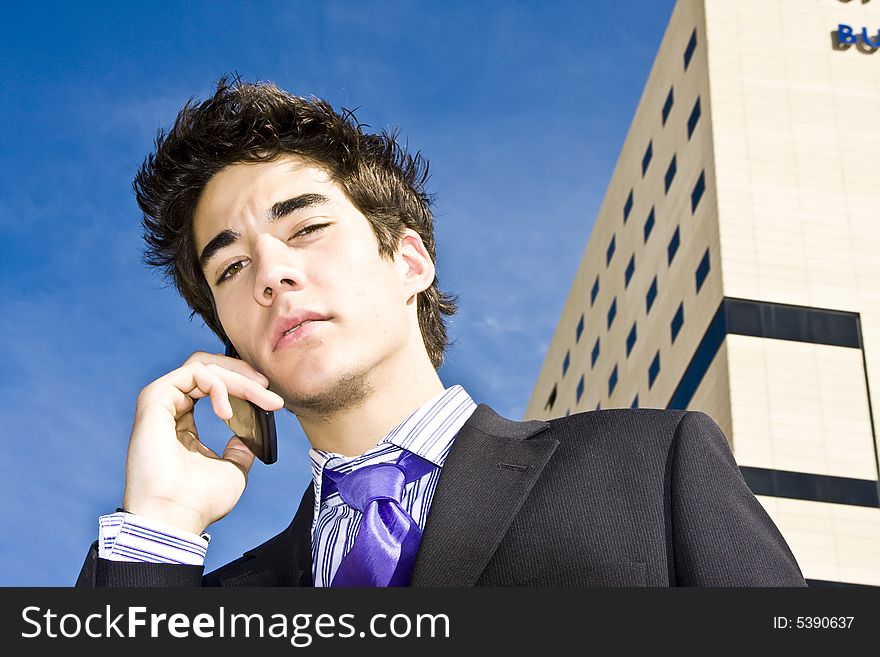 Businessman on phone over urban background