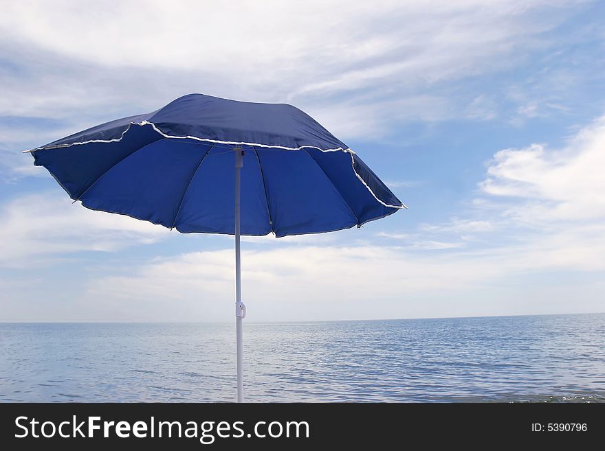 Blue umbrella on sky background