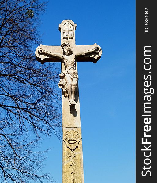 Stone crucifix with Jesus sculpture. Stone crucifix with Jesus sculpture