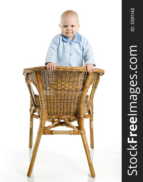 A photo of a baby boy, standing on chair