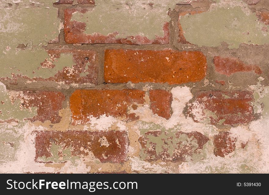A close-up of a flaking brick wall. A close-up of a flaking brick wall