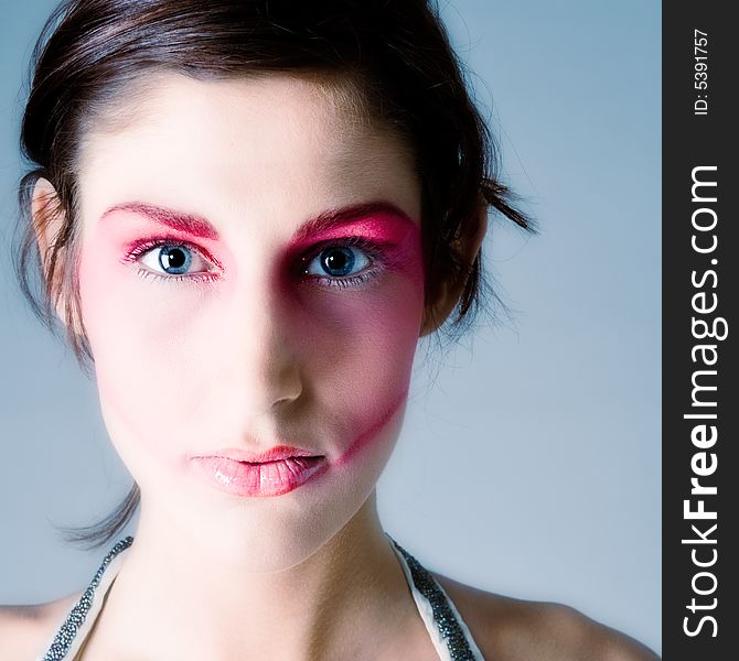 Close studio portrait of a pretty brunette with special artistic cosmetics. Close studio portrait of a pretty brunette with special artistic cosmetics