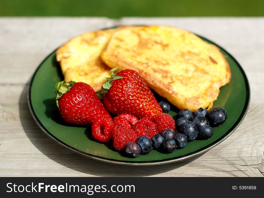 French toast breakfast with fresh berries outdoors