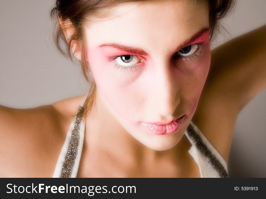 Close studio portrait of a pretty brunette with special artistic cosmetics. Close studio portrait of a pretty brunette with special artistic cosmetics