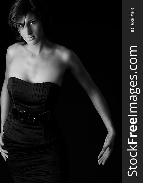 Studio portrait of a tall lady in a black dress on a black background. Studio portrait of a tall lady in a black dress on a black background