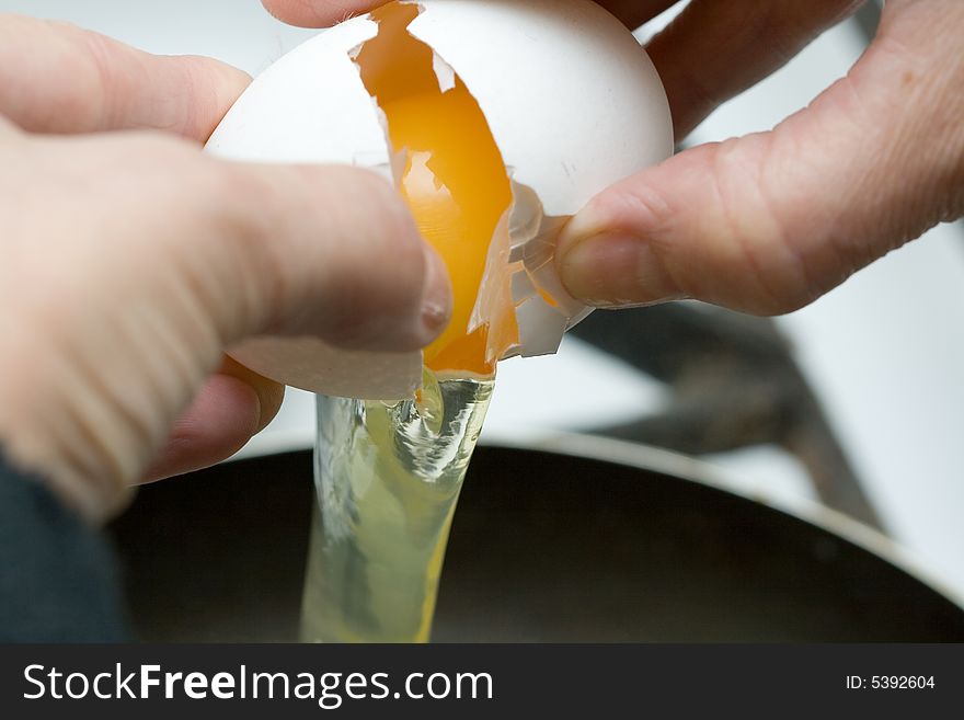 Frying the egg in griddle close-up