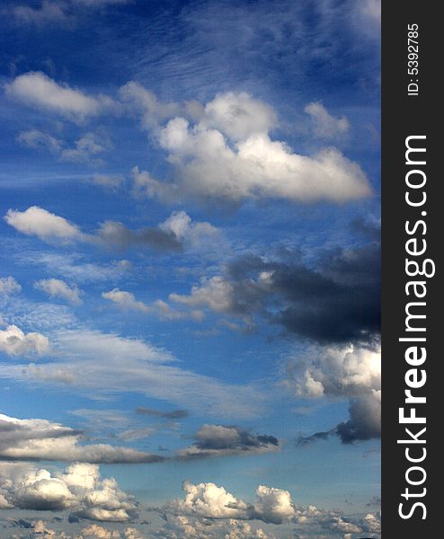 Puffy white clouds in a bright blue sky.