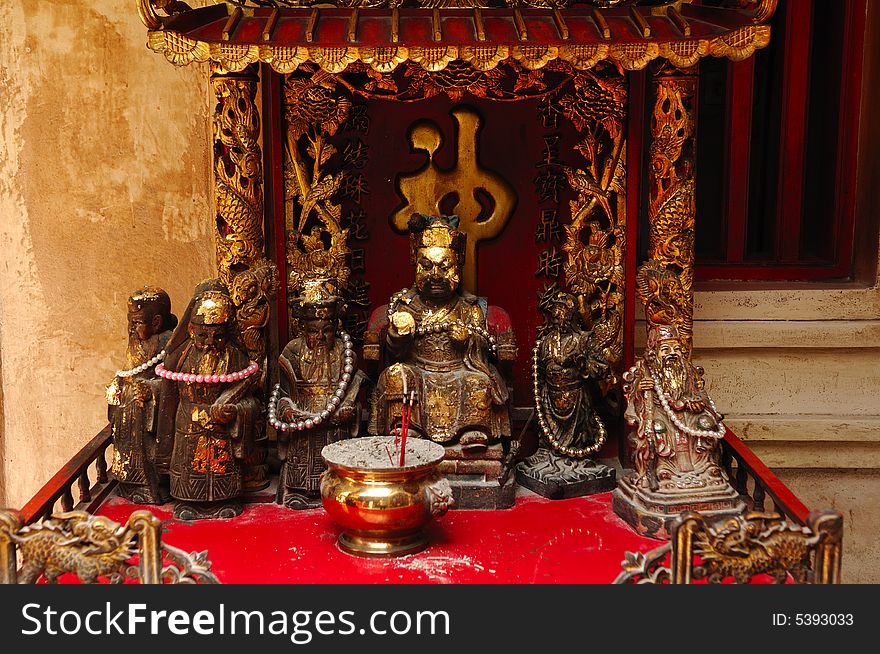 In Thailand the city of Ayutthaya was founded in 1350 today is an impressive archaeological park; here a view of a altar inside a Chinese temple on the back of Wat Phanan-Choeng. In Thailand the city of Ayutthaya was founded in 1350 today is an impressive archaeological park; here a view of a altar inside a Chinese temple on the back of Wat Phanan-Choeng