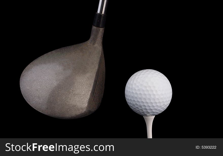 Golf ball on tee with driver w clipping path on black background