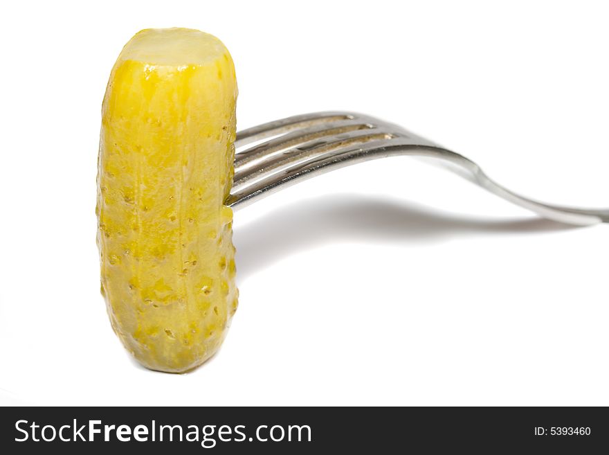 Close-up marinated cucumber on fork, isolated on white. Close-up marinated cucumber on fork, isolated on white