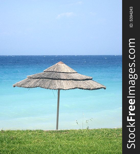 Sunshade on the grass beach of the sea. Sunshade on the grass beach of the sea