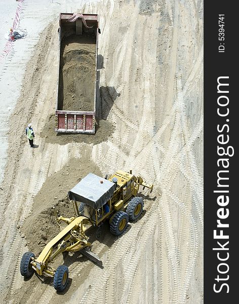 Two heavy construction machinery working back to back. Two heavy construction machinery working back to back