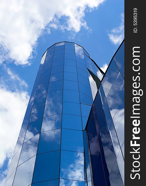 Clouds and sky reflect in glass tower. Clouds and sky reflect in glass tower