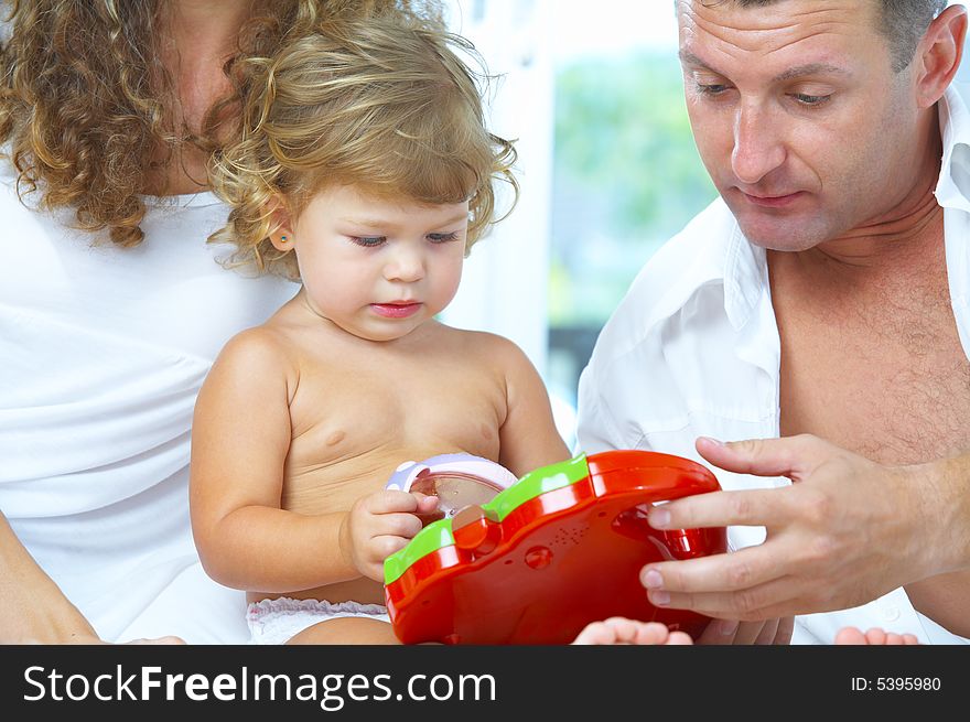 High key portrait of nice young family getting busy. High key portrait of nice young family getting busy