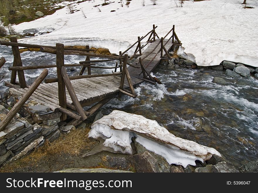 Wood bridge broken by snow. Wood bridge broken by snow