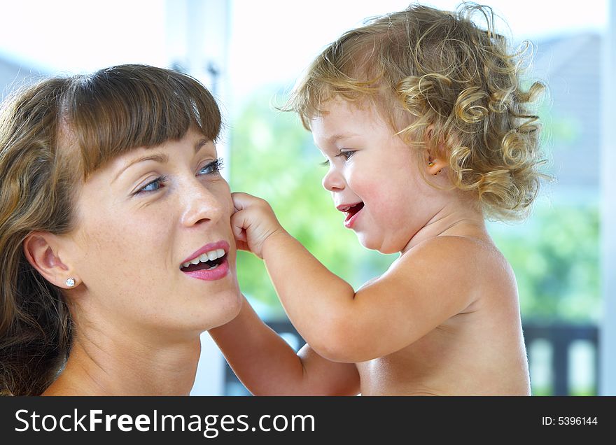 High key portrait of happy mother with baby. High key portrait of happy mother with baby