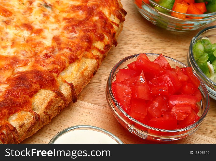 Freadh baked cheese bread pizza and toppings.  Green onion, bell peppers, green salsa, ranch dressing, chopped tomatoes. Freadh baked cheese bread pizza and toppings.  Green onion, bell peppers, green salsa, ranch dressing, chopped tomatoes.