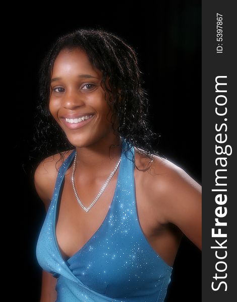 Pretty teenage girl in sparkly blue halter gown; head and shoulders shot. Pretty teenage girl in sparkly blue halter gown; head and shoulders shot.