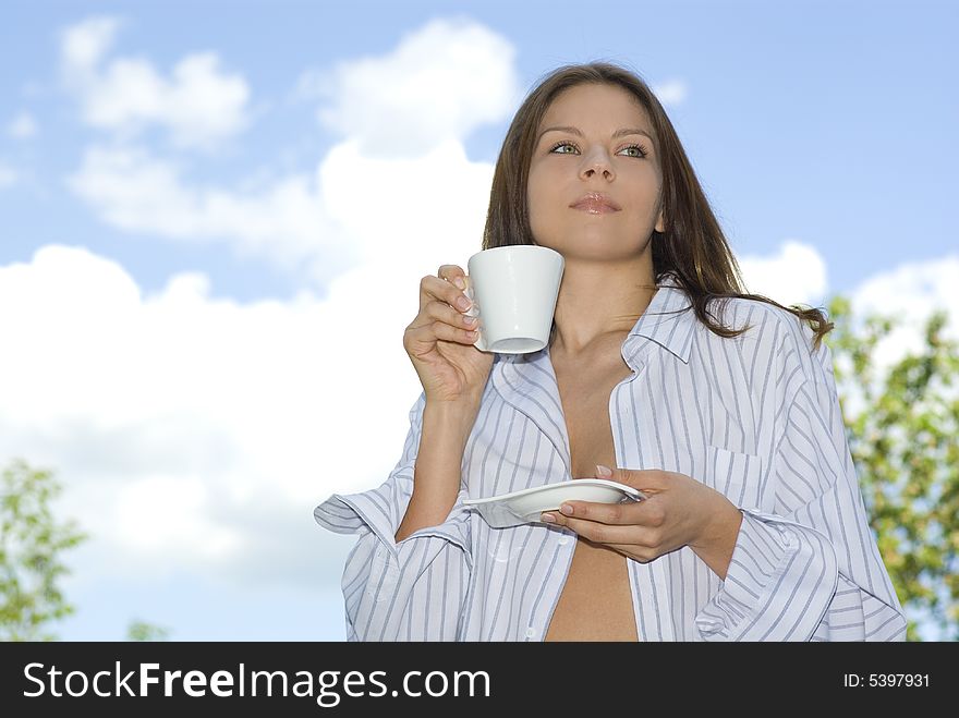 Young Woman Relaxing, Drinking Coffee At Mountain