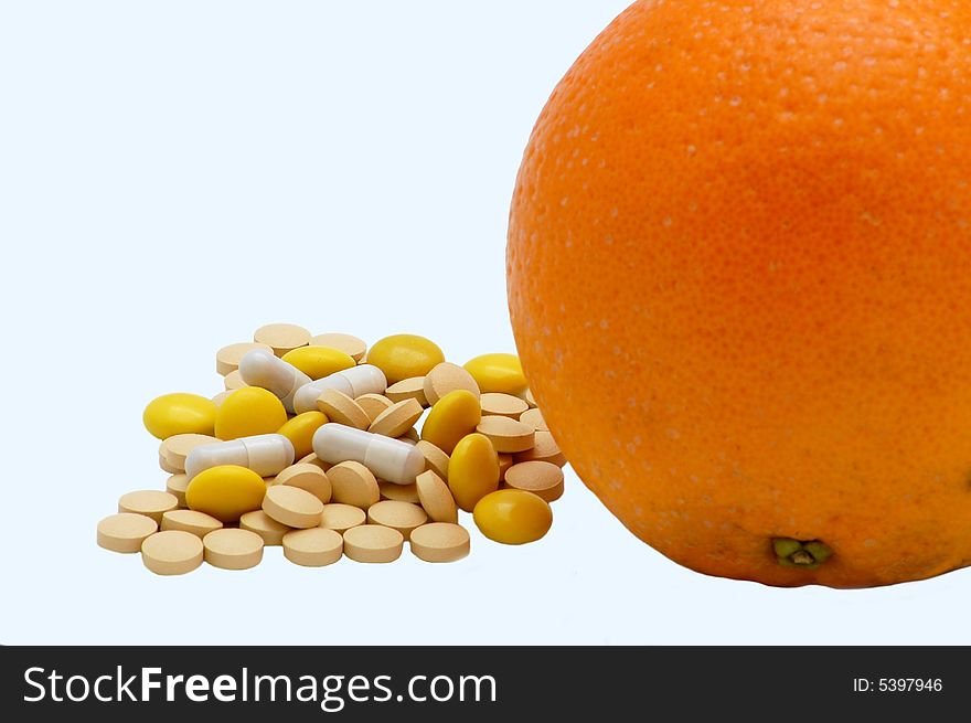 Vitamins and orange isolated on the white background. Vitamins and orange isolated on the white background