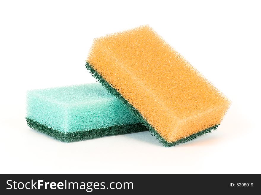 Two sponges lay on a white surface