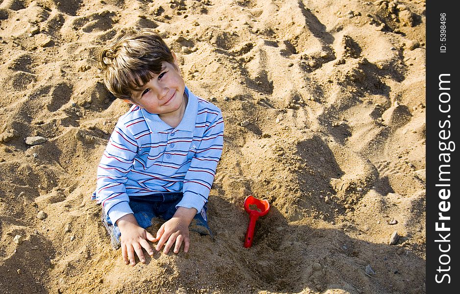 The boy playing in the sand