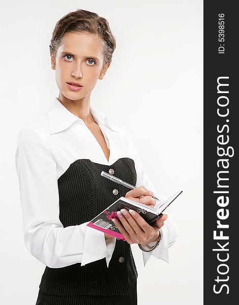 Attractive Fine business-lady holds a book And the handle