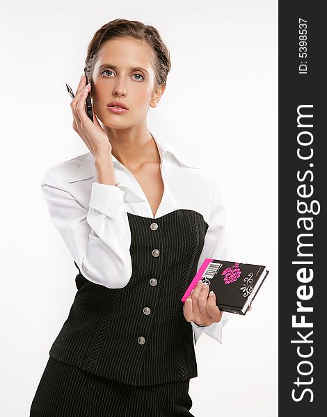 Attractive Fine business-lady holds phone and a book
