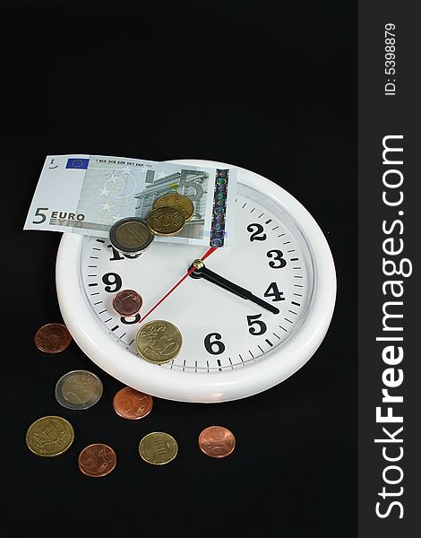 White clock and money on black background as symbol and sample for my isolated business and concept images. White clock and money on black background as symbol and sample for my isolated business and concept images
