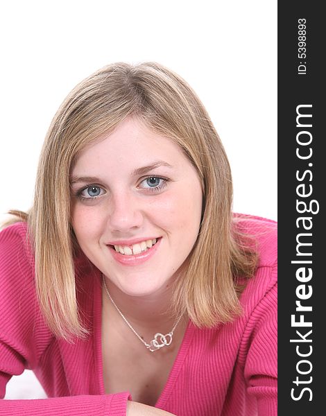 Pretty teenage girl in pink shirt against a white background.